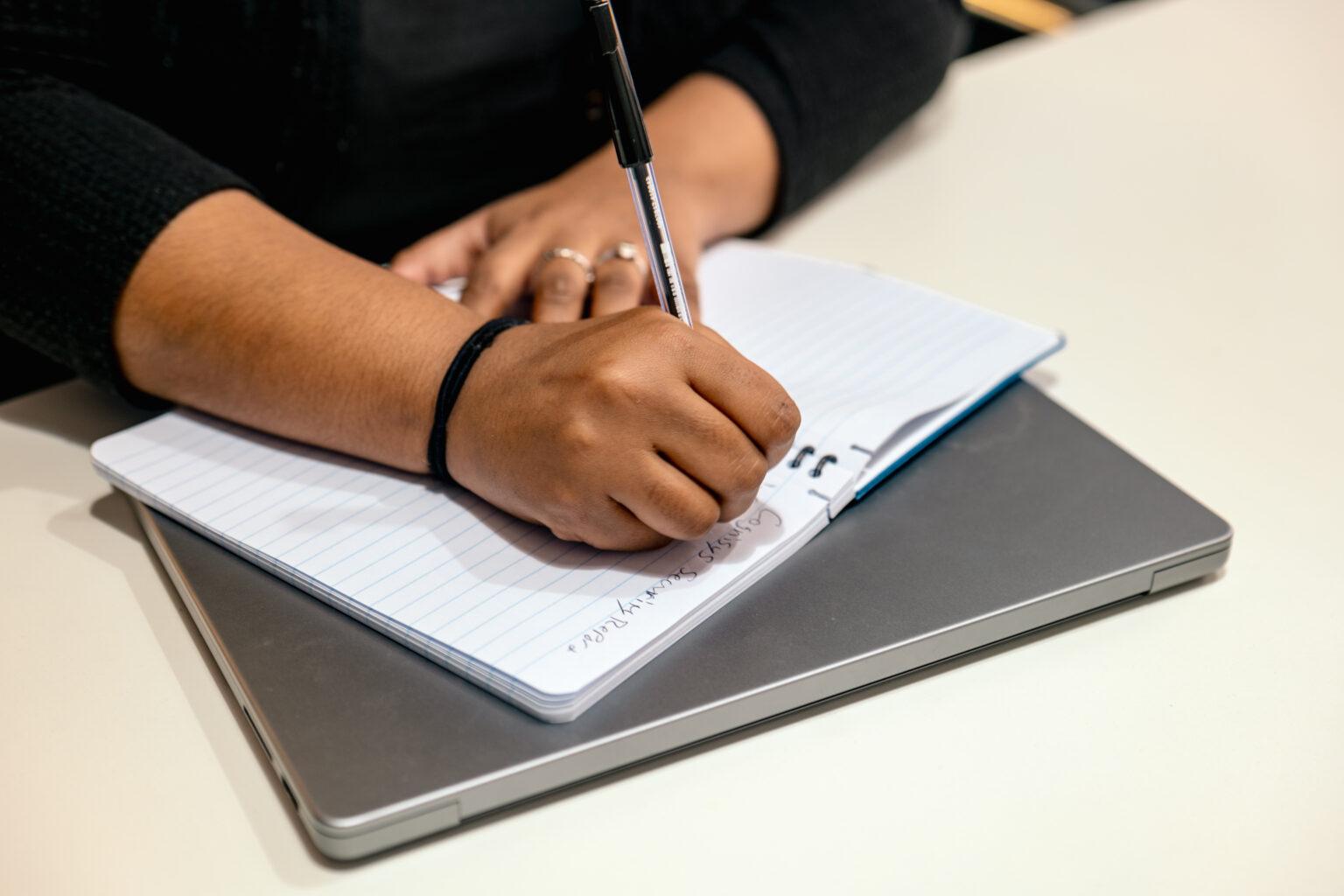 GRC consultant taking notes during an ISO 27001 audit, ensuring compliance with information security standards.